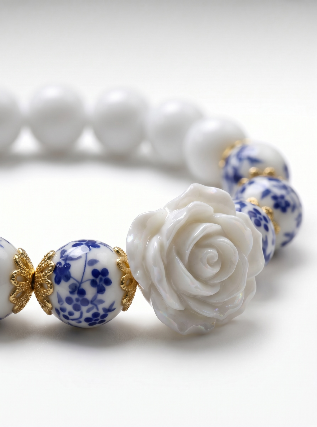 Rosie- Bracelet-Delicate Beauty For Everyday. White Chalcedony & Porcelain Bead Stretchy Bracelet. With Central White Rose Detail and 18k Gold Plated Bead Cups.
Handcrafted by Artist Kristine Keina