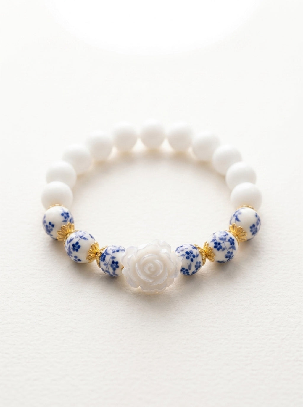 Rosie- Bracelet-Delicate Beauty For Everyday. White Chalcedony & Porcelain Bead Stretchy Bracelet. With Central White Rose Detail and 18k Gold Plated Bead Cups.
Handcrafted by Artist Kristine Keina