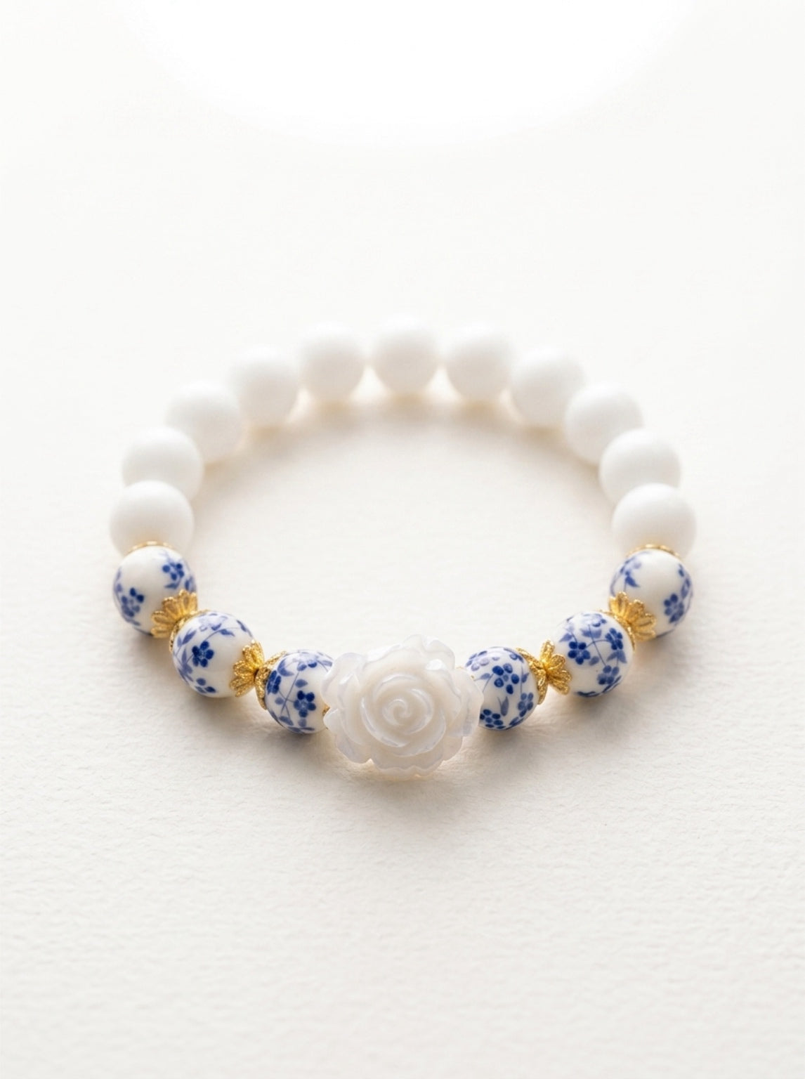 Rosie- Bracelet-Delicate Beauty For Everyday. White Chalcedony & Porcelain Bead Stretchy Bracelet. With Central White Rose Detail and 18k Gold Plated Bead Cups.
Handcrafted by Artist Kristine Keina